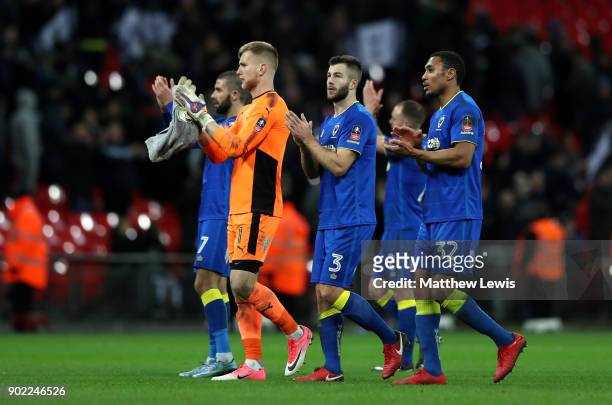 Wimbledon players show appreciation to the fans following The Emirates FA Cup Third Round match between Tottenham Hotspur and AFC Wimbledon at...