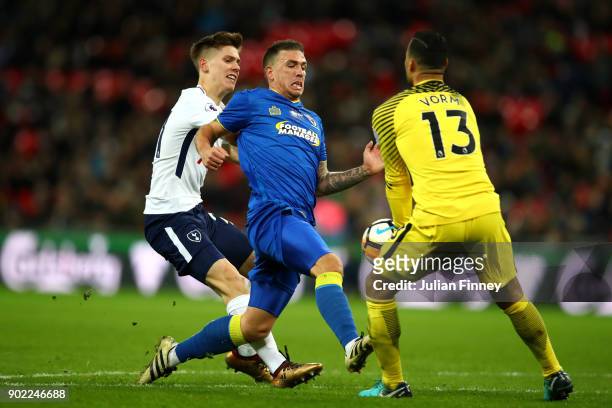 Cody McDonald of AFC Wimbledon is chased down by Juan Foyth and Michel Vorm of Tottenham Hotspur during The Emirates FA Cup Third Round match between...