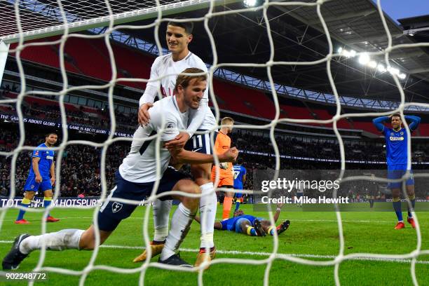 Harry Kane of Tottenham Hotspur celebrates scoring his side's first goal with Erik Lamela during The Emirates FA Cup Third Round match between...