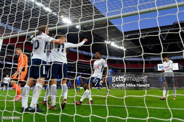 Harry Kane of Tottenham Hotspur celebrates scoring his side's first goal with team mates during The Emirates FA Cup Third Round match between...