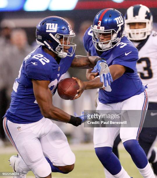 Quarterback Geno Smith of the New York Giants hands off to Wayne Gallman in an NFL football game against the Los Angeles Rams on November 5, 2017 at...