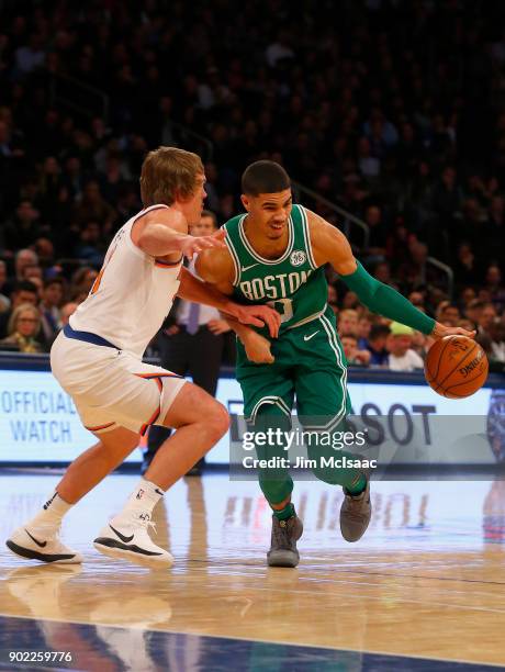 Jayson Tatum of the Boston Celtics in action against Ron Baker of the New York Knicks at Madison Square Garden on December 21, 2017 in New York City....