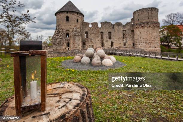castle ruins with candle lamp on foreground in cesis, latvia - cesis latvia stock pictures, royalty-free photos & images