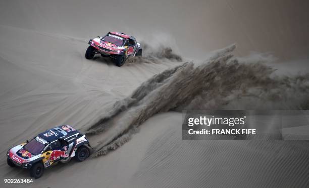 Peugeot's Spanish driver Carlos Sainz and co-driver Lucas Cruz and Peugeot's French driver Cyril Despres and co-driver David Castera compete during...