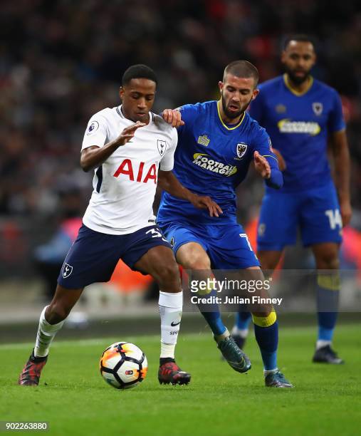 George Francomb of AFC Wimbledon battles with Kyle Walker-Peters of Spurs during The Emirates FA Cup Third Round match between Tottenham Hotspur and...