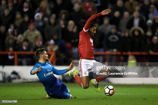 Mathieu Debuchy of Arsenal brings down Armand Traore of Nottingham Forest leading to his team's second penalty during The Emirates FA Cup Third Round...