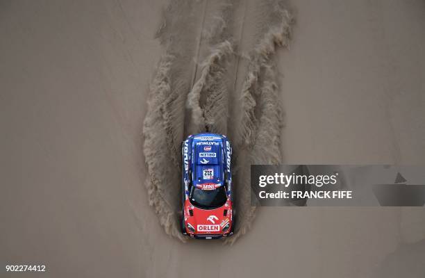 Mini's Polish driver Jakub Przygonski and Belgian co-driver Tom Colsoul compete during the 2018 Dakar Rally Stage 2 in and around the Peruvian town...