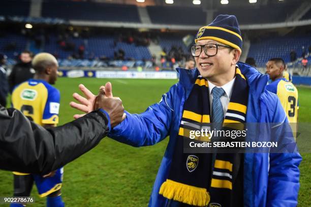 Sochaux' Chinese owner Wing Sang Li congratulates Sochaux' players at the end of the French Cup football match between Sochaux vs Amiens at the...