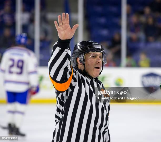 Hockey East Association Referee John Gravallese makes a call during a game between the Massachusetts Lowell River Hawks and the Vermont Catamounts...