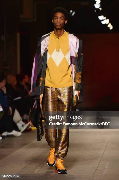 Model walks the runway at the Astrid Andersen show during London Fashion Week Men's January 2018 at Old Selfridges Hotel on January 7, 2018 in...