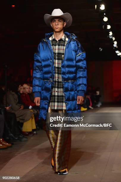 Model walks the runway at the Astrid Andersen show during London Fashion Week Men's January 2018 at Old Selfridges Hotel on January 7, 2018 in...