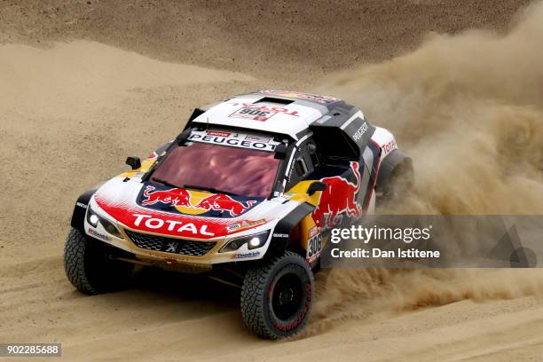 Sebastien Loeb of France and Peugeot Total drives with co-driver Daniel Elena of Monaco in the 3008 DKR Peugeot car in the Classe : T1.4 2 Roues...