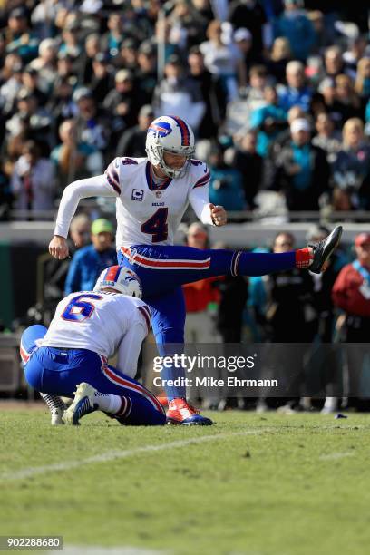 Holder Colton Schmidt looks on as kicker Stephen Hauschka of the Buffalo Bills kicks a second quarter field goal against the Jacksonville Jaguars...