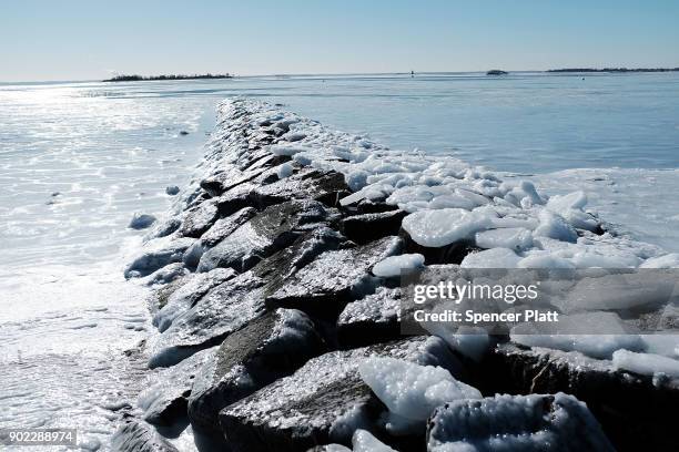 Frozen jetty stands in the icy waters of Long Island Sound as temperatures continue to stay below freezing in much of the Northeast on January 7,...