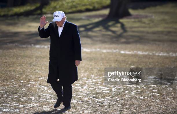 President Donald Trump waves, while returning from a weekend trip with Republican leadership to Camp David, on the South Lawn of the White House in...