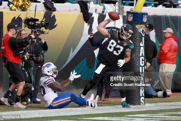 Tight end Ben Koyack of the Jacksonville Jaguars spikes the ball in front of outside linebacker Ramon Humber of the Buffalo Bills after catching a...
