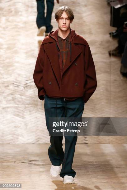 Model walks the runway at the Qasami show during London Fashion Week Men's January 2018 at 100 Sydney Street on January 6, 2018 in London, England.