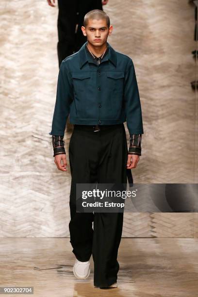 Model walks the runway at the Qasami show during London Fashion Week Men's January 2018 at 100 Sydney Street on January 6, 2018 in London, England.