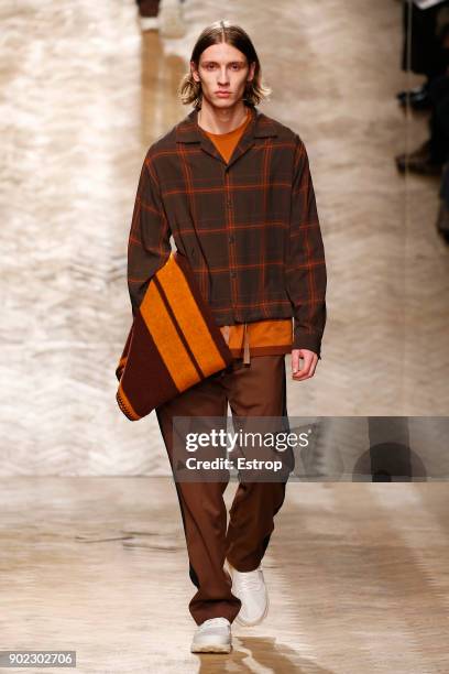 Model walks the runway at the Qasami show during London Fashion Week Men's January 2018 at 100 Sydney Street on January 6, 2018 in London, England.