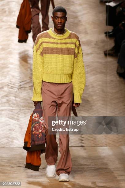 Model walks the runway at the Qasami show during London Fashion Week Men's January 2018 at 100 Sydney Street on January 6, 2018 in London, England.