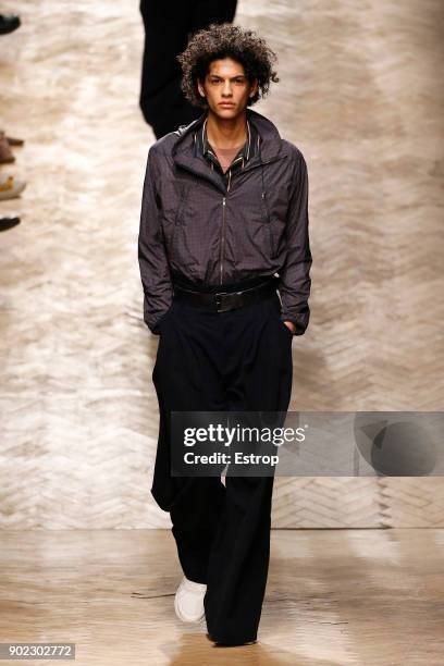 Model walks the runway at the Qasami show during London Fashion Week Men's January 2018 at 100 Sydney Street on January 6, 2018 in London, England.