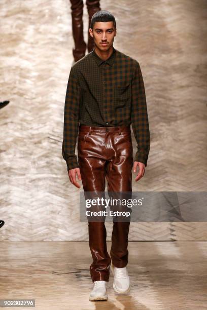 Model walks the runway at the Qasami show during London Fashion Week Men's January 2018 at 100 Sydney Street on January 6, 2018 in London, England.