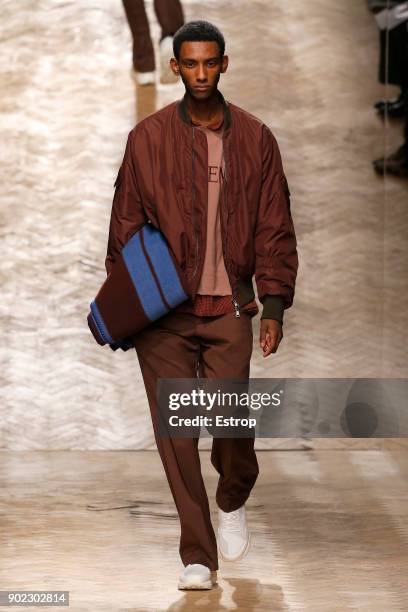 Model walks the runway at the Qasami show during London Fashion Week Men's January 2018 at 100 Sydney Street on January 6, 2018 in London, England.