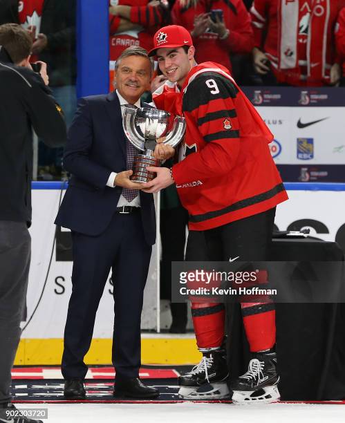 René Fasel president of the IIHF and Dillon Dubé of Canada with the tournament trophy after Canada won against Sweden during the Gold medal game of...