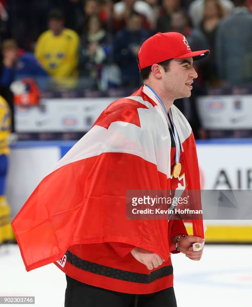 Dillon Dubé of Canada wearing a Canadian flag after winning against Sweden during the Gold medal game of the IIHF World Junior Championship at...