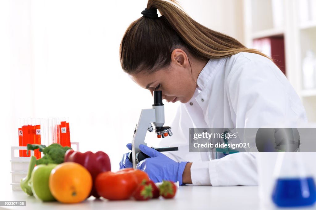 Cheking food quality at professional lab with microscope