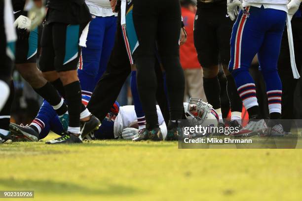 Quarterback Tyrod Taylor of the Buffalo Bills lays on the field after taking a hit and leaving the game late in the fourth quarter against the...
