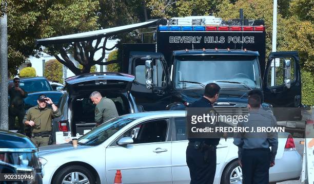 Police and security surround the Beverly Hilton Hotel in Beverly Hills, California on January 7, 2018 for the 75th Annual Gloden Globe Awards. / AFP...