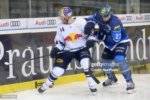 Steve Pinizzotto of Red Bull Munich vies Matt Pelech of ERC Ingolstadt during the 40th game day of the German Ice Hockey League between ERC...