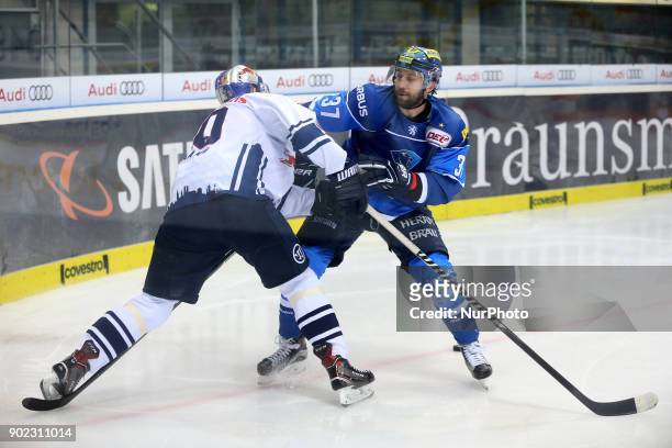 Sean Sullivan of ERC Ingolstadt vies Jerome Flaake of Red Bull Munich during the 40th game day of the German Ice Hockey League between ERC Ingolstadt...