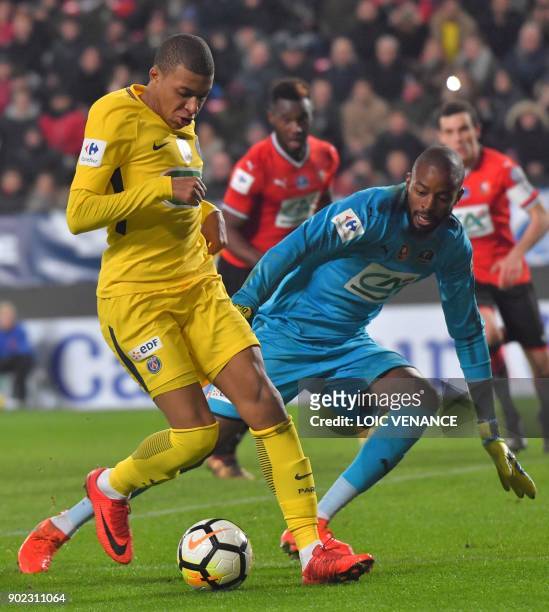 Paris Saint-Germain's French forward Kylian Mbappe vies with Rennes' French goalkeeper Abdoulaye Diallo during the French cup football match Rennes...