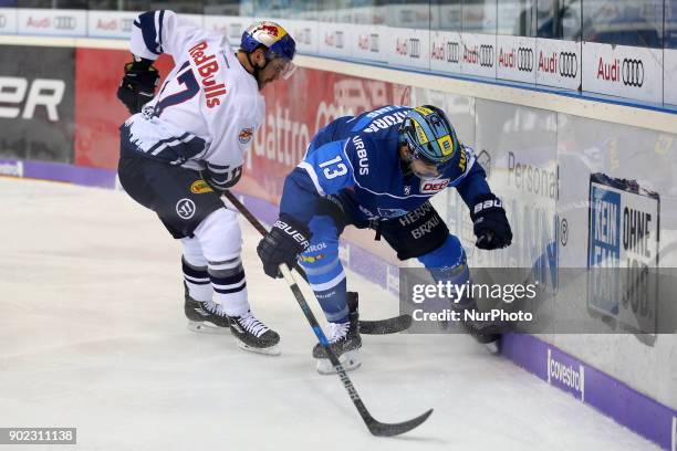 Brooks Macek of Red Bull Munich vies Mike Collins of ERC Ingolstadt during the 40th game day of the German Ice Hockey League between ERC Ingolstadt...