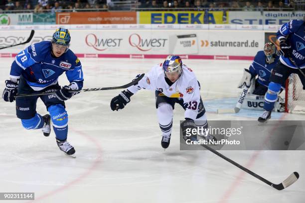 Ville Koistinen of ERC Ingolstadt vies Michael Wolf of Red Bull Munich during the 40th game day of the German Ice Hockey League between ERC...