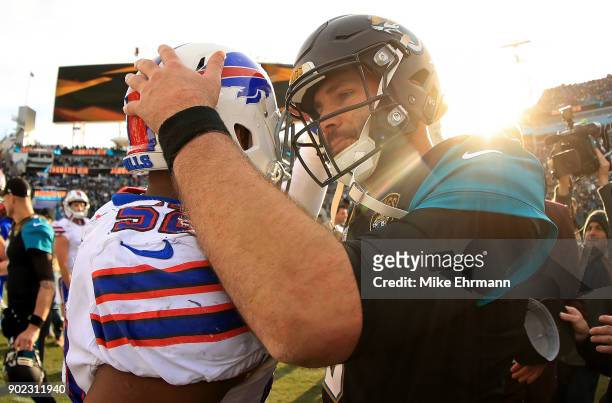 Blake Bortles of the Jacksonville Jaguars shakes hands with Preston Brown of the Buffalo Bills after winning the AFC Wild Card playoff game at...