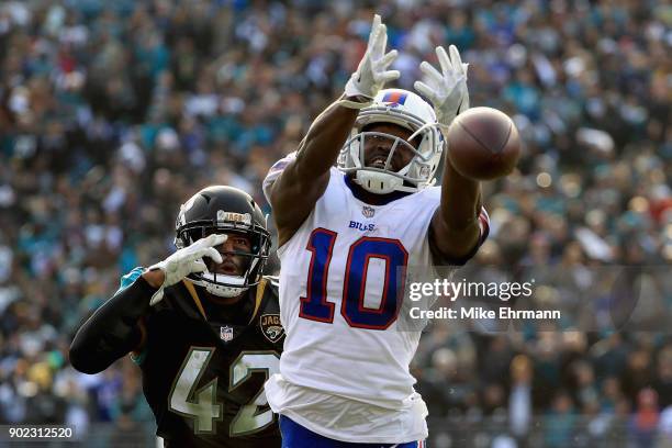 Wide receiver Deonte Thompson of the Buffalo Bills misses a fourth quarter pass as strong safety Barry Church of the Jacksonville Jaguars defends in...