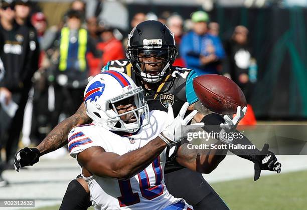 Deonte Thompson of the Buffalo Bills and A.J. Bouye of the Jacksonville Jaguars battle for the football in the first half of the AFC Wild Card Round...