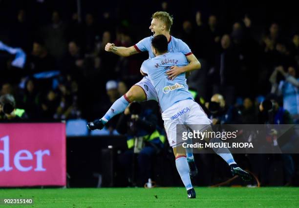 Celta Vigo's Uruguayan forward Maxi Gomez celebrates with Danish midfielder Daniel Wass after scoring a goal during the Spanish league football match...