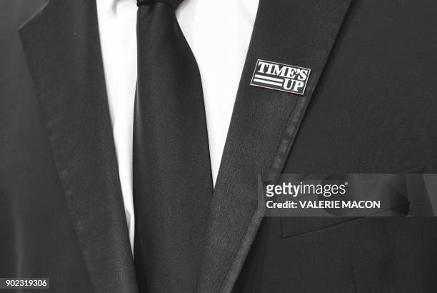 An attendee wears a 'Times Up' badge as he arrives for the 75th Golden Globe Awards on January 7 in Beverly Hills, California.