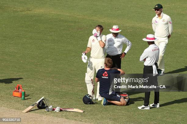 Joe Root of England has an injured finger treated during day four of the Fifth Test match in the 2017/18 Ashes Series between Australia and England...
