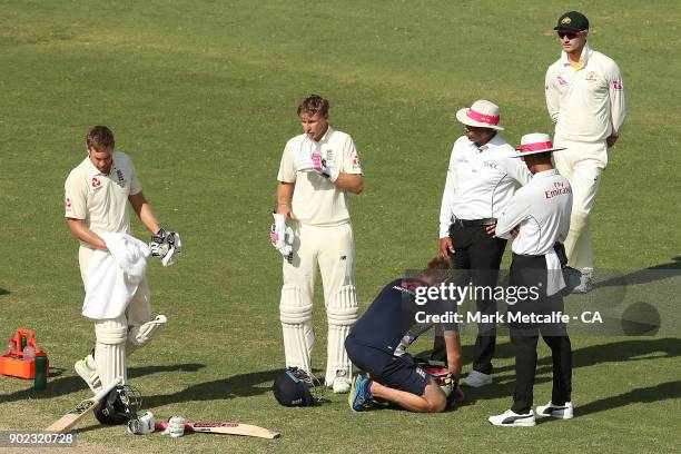 Joe Root of England drinks water as his injured finger is treated during day four of the Fifth Test match in the 2017/18 Ashes Series between...