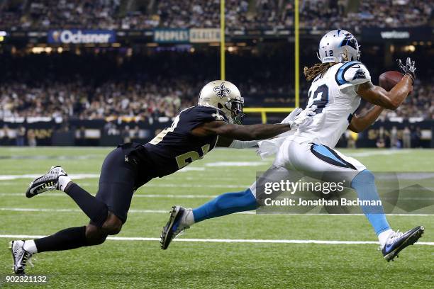 Charles D. Johnson of the Carolina Panthers attempts to catch the ball as Ken Crawley of the New Orleans Saints defends during the first half of the...
