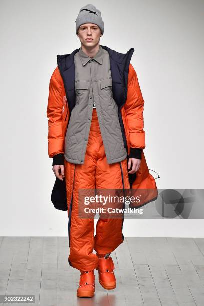 Model walks the runway at the Christopher Raeburn Autumn Winter 2018 fashion show during London Menswear Fashion Week on January 7, 2018 in London,...