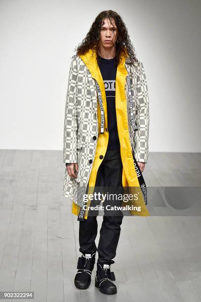 Model walks the runway at the Christopher Raeburn Autumn Winter 2018 fashion show during London Menswear Fashion Week on January 7, 2018 in London,...