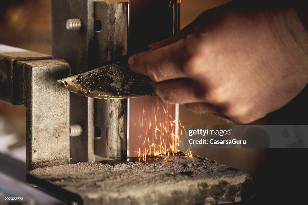 Close-up of a Man Sharpening a Knife