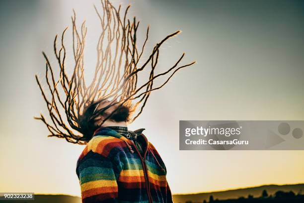 young caucasian man swinging dreadlocks - rastafarian stock pictures, royalty-free photos & images