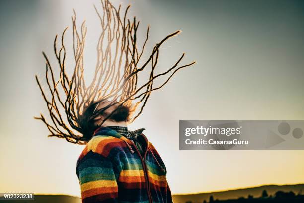 young caucasian man swinging dreadlocks - white rasta stock pictures, royalty-free photos & images